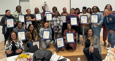 Photo features about two dozen of Oakland's early learning leaders as they hold their awards of recognition